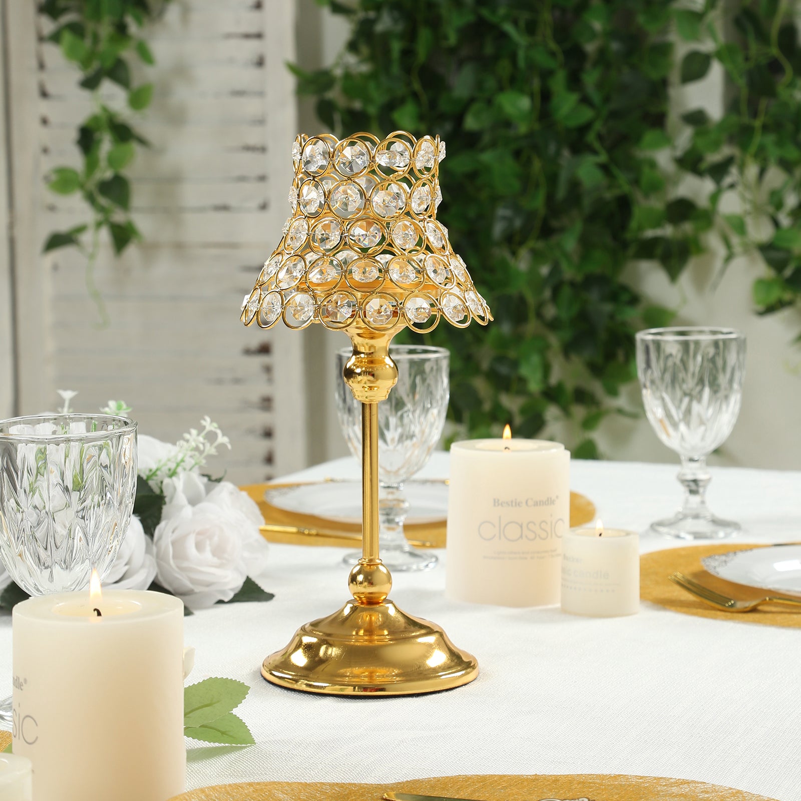 Gold crystal beaded candle holder with lamp-inspired shade for elegant table decor.