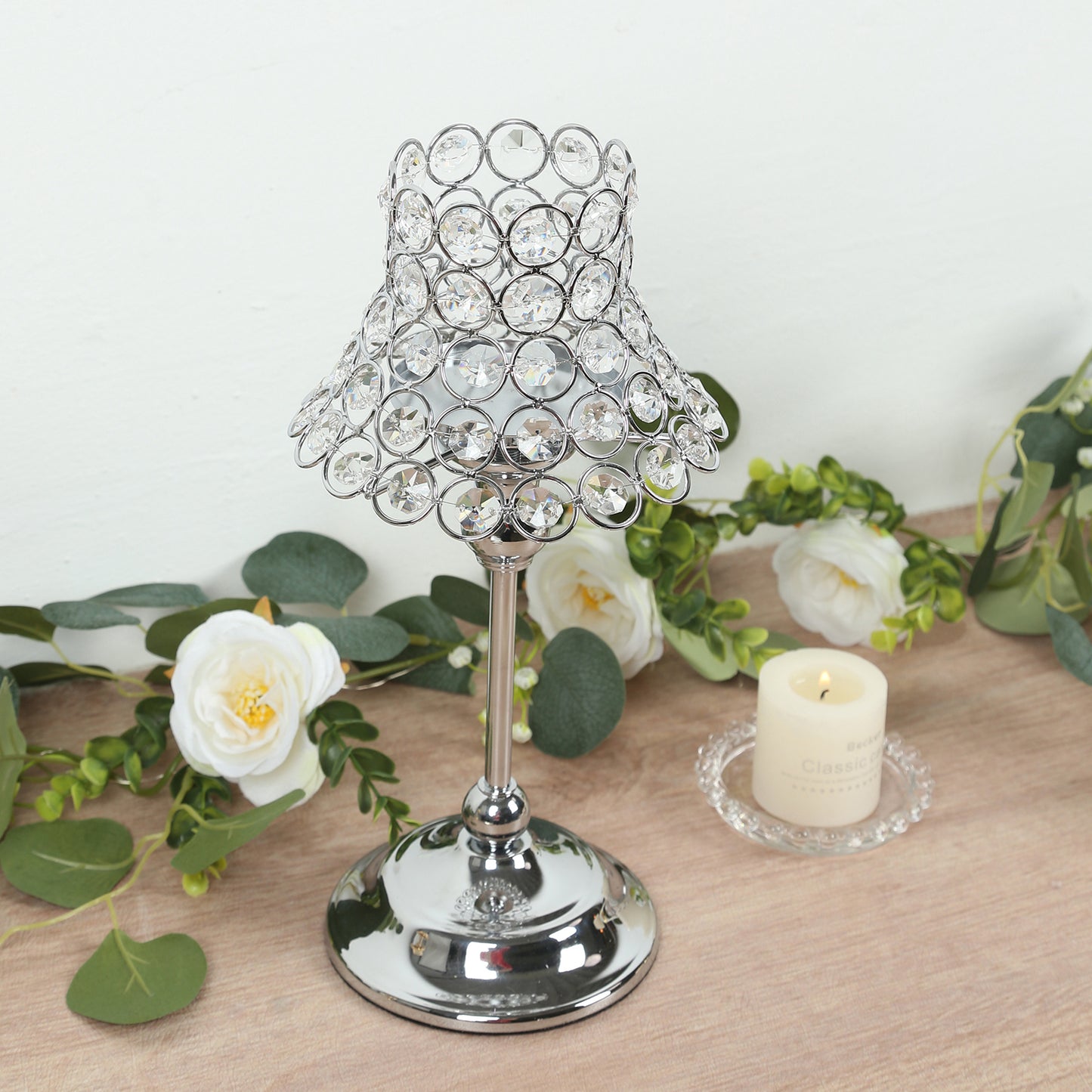 Silver crystal beaded candle holder with lamp-inspired shade and floral decor.