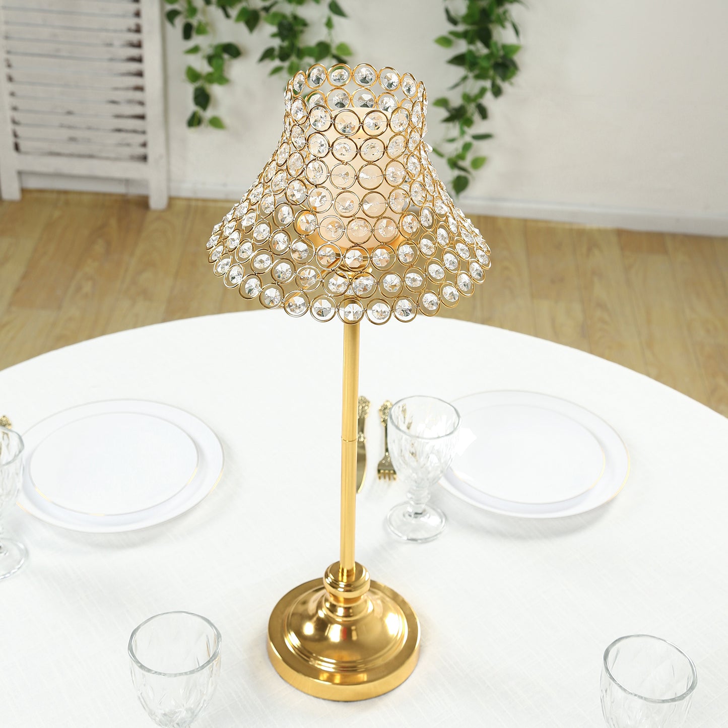 Gold crystal beaded candle stand with lamp-inspired shade for tables.