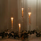 Clear acrylic hurricane candle stands with taper candles and glass chimneys.