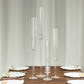 Clear acrylic hurricane candle stands in varying heights.