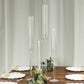 Clear acrylic hurricane candle stands with tall chimneys for elegant decor.
