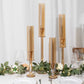 Amber gold hurricane candle holders in a decorative setting.