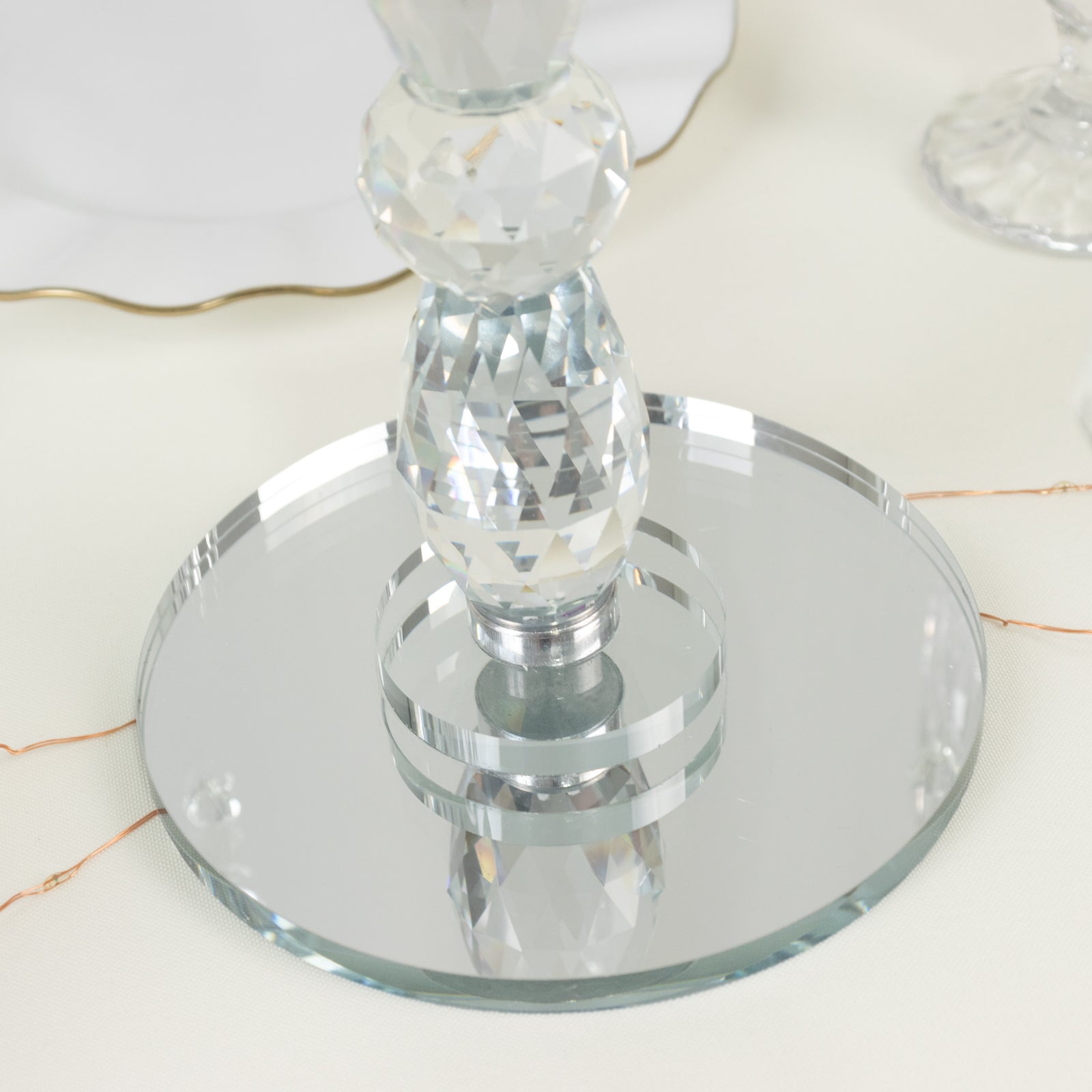 Clear crystal candle holder with 5 arms and hanging pendants, elegant centerpiece.