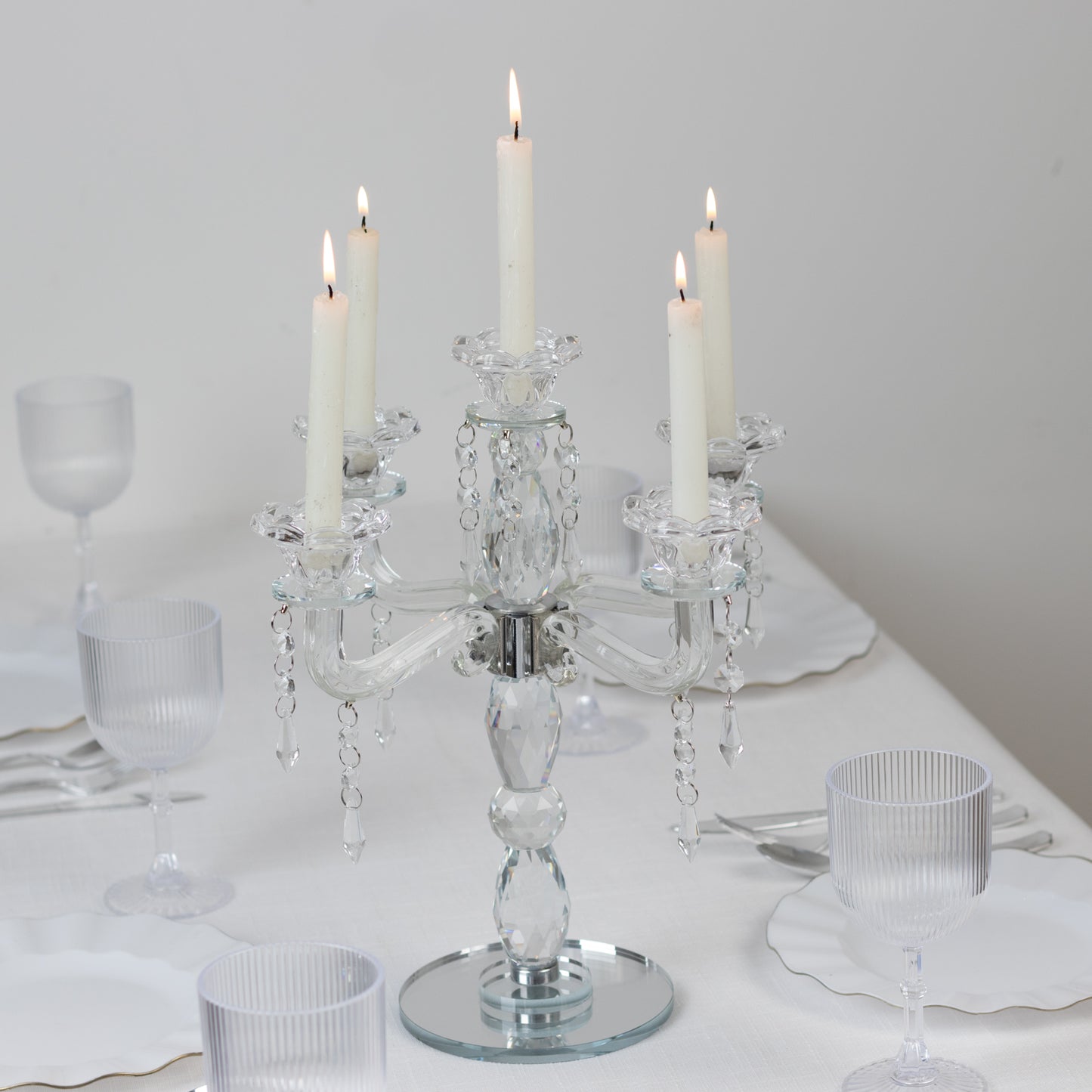 Crystal taper candle holder with 5 arms, elegant centerpiece in clear glass.