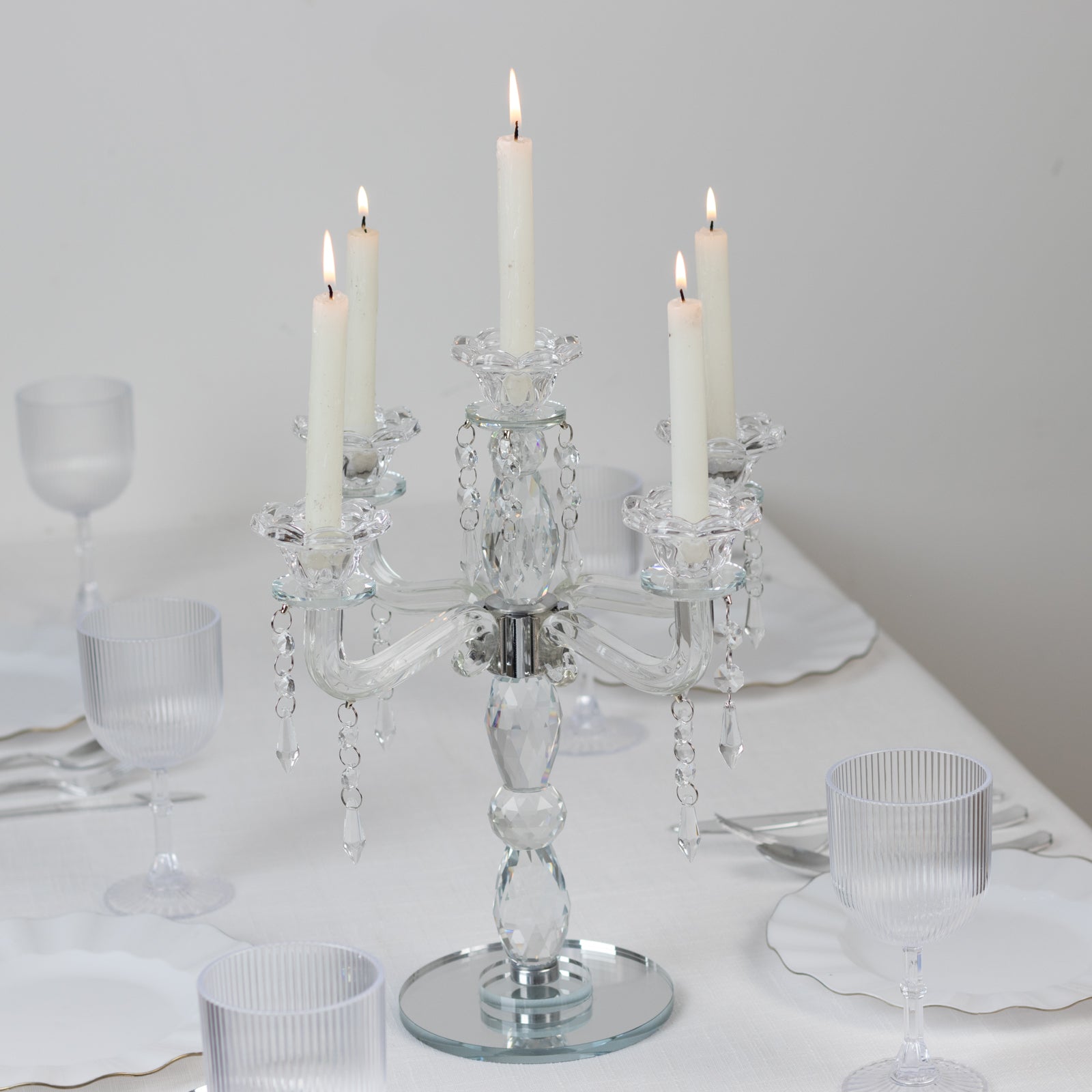 Crystal taper candle holder with 5 arms, elegant centerpiece in clear glass.