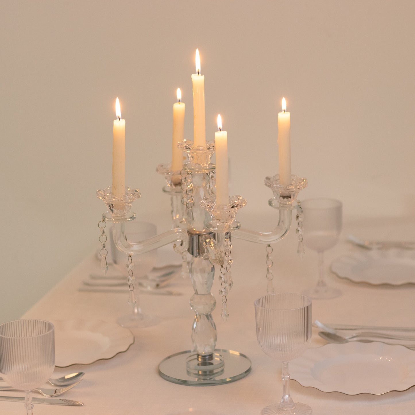 Elegant crystal taper candle holder with 5 arms and hanging pendants.