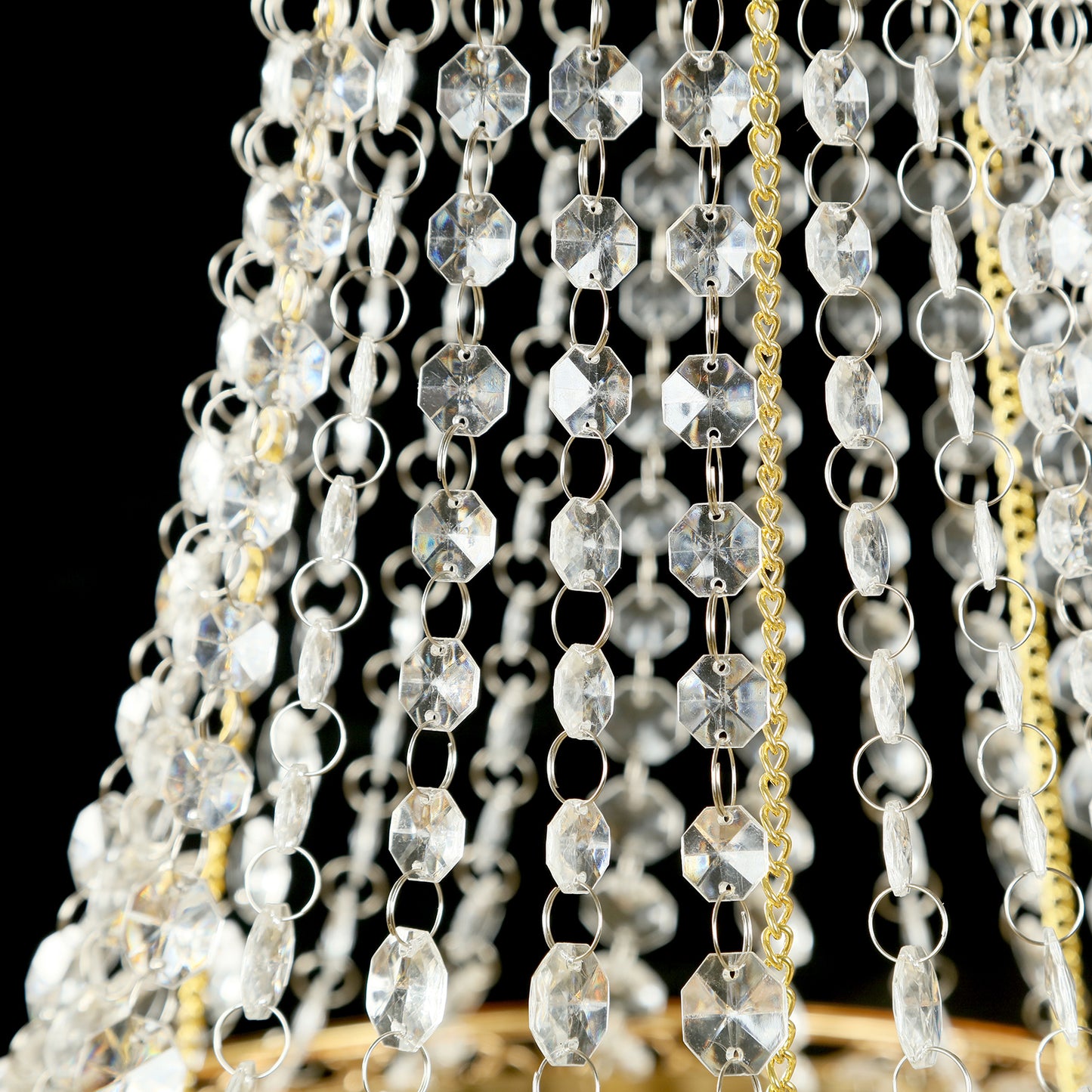 Gold beaded crystal chandelier with ornate metal frame.