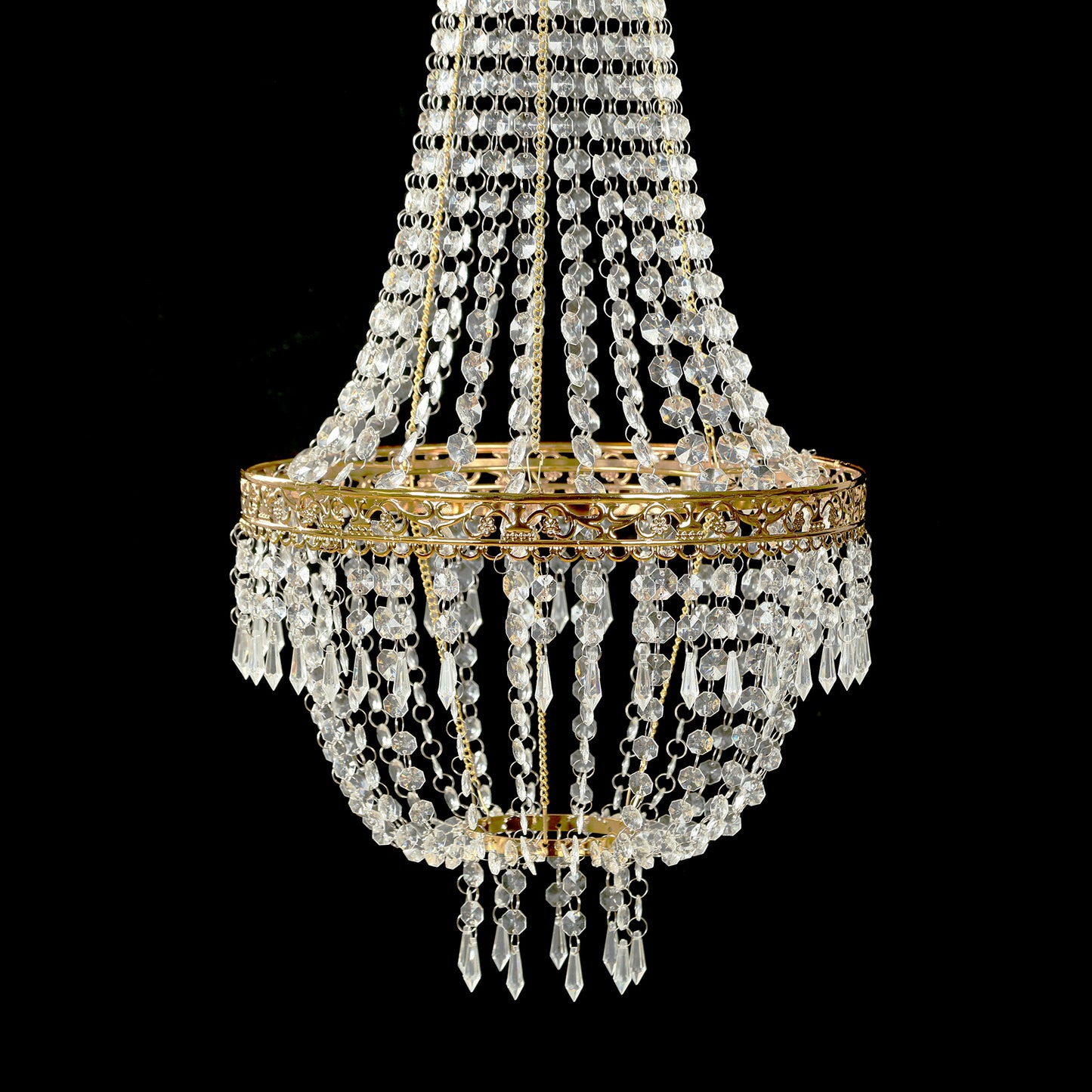 Gold beaded crystal chandelier with ornate metal frame.