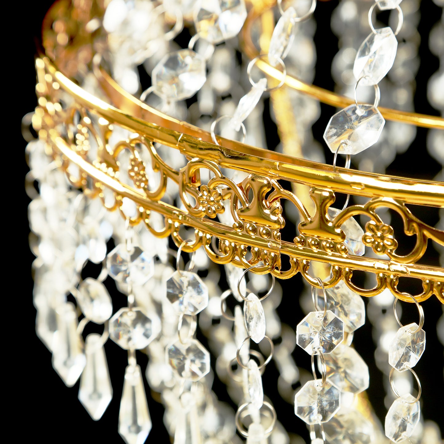 Gold beaded crystal chandelier with ornate metal frame.