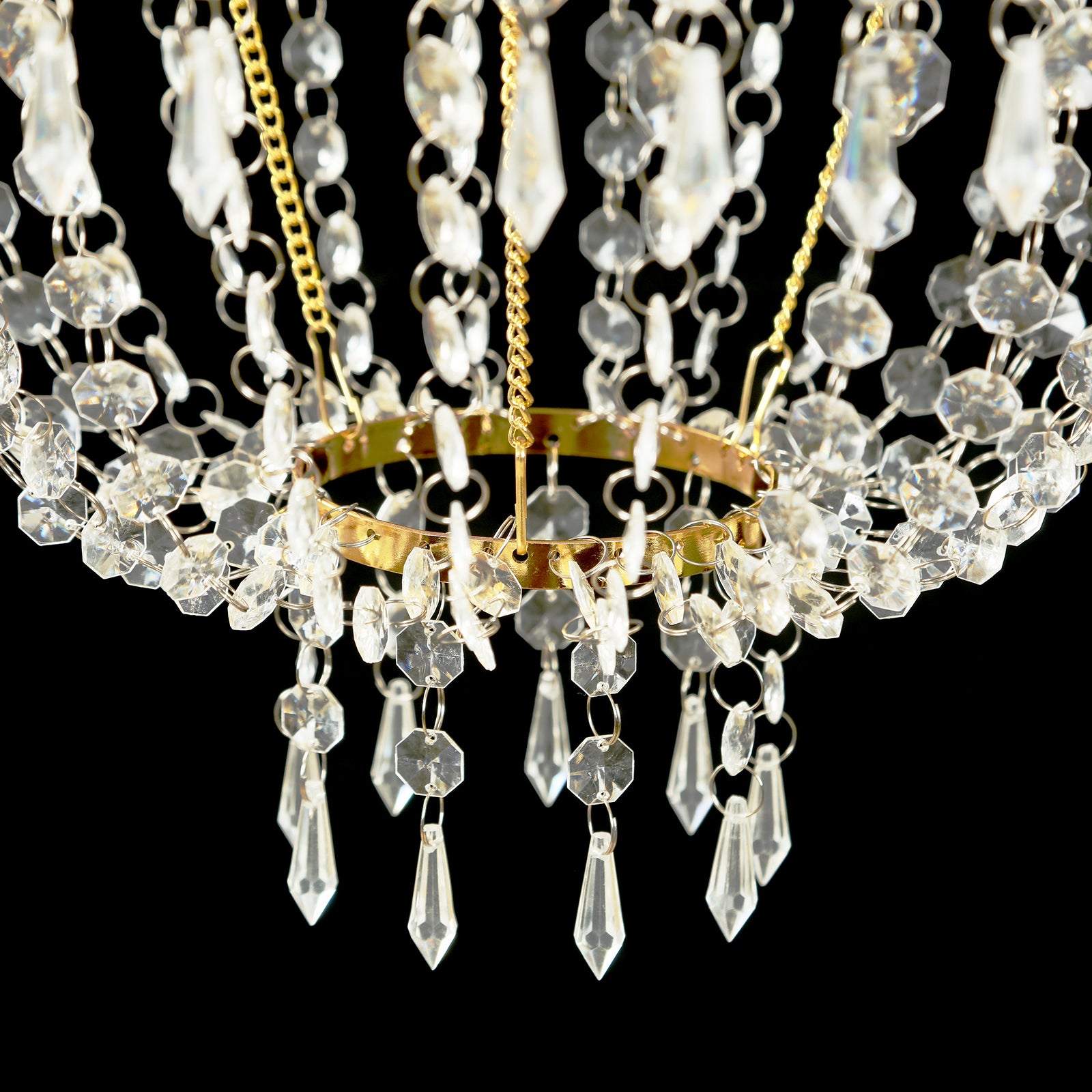 Gold beaded crystal chandelier with ornate metal frame.