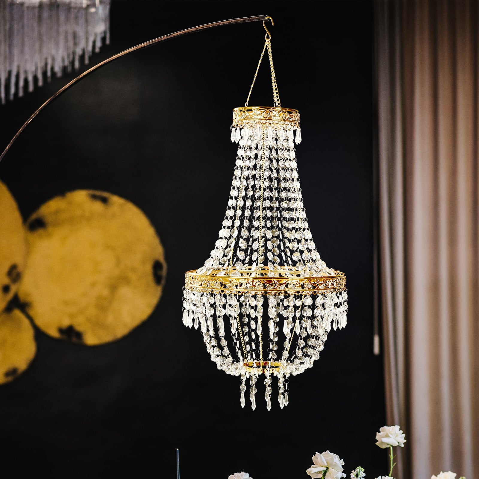 Gold beaded crystal chandelier with ornate metal frame, adjustable pendant lighting.