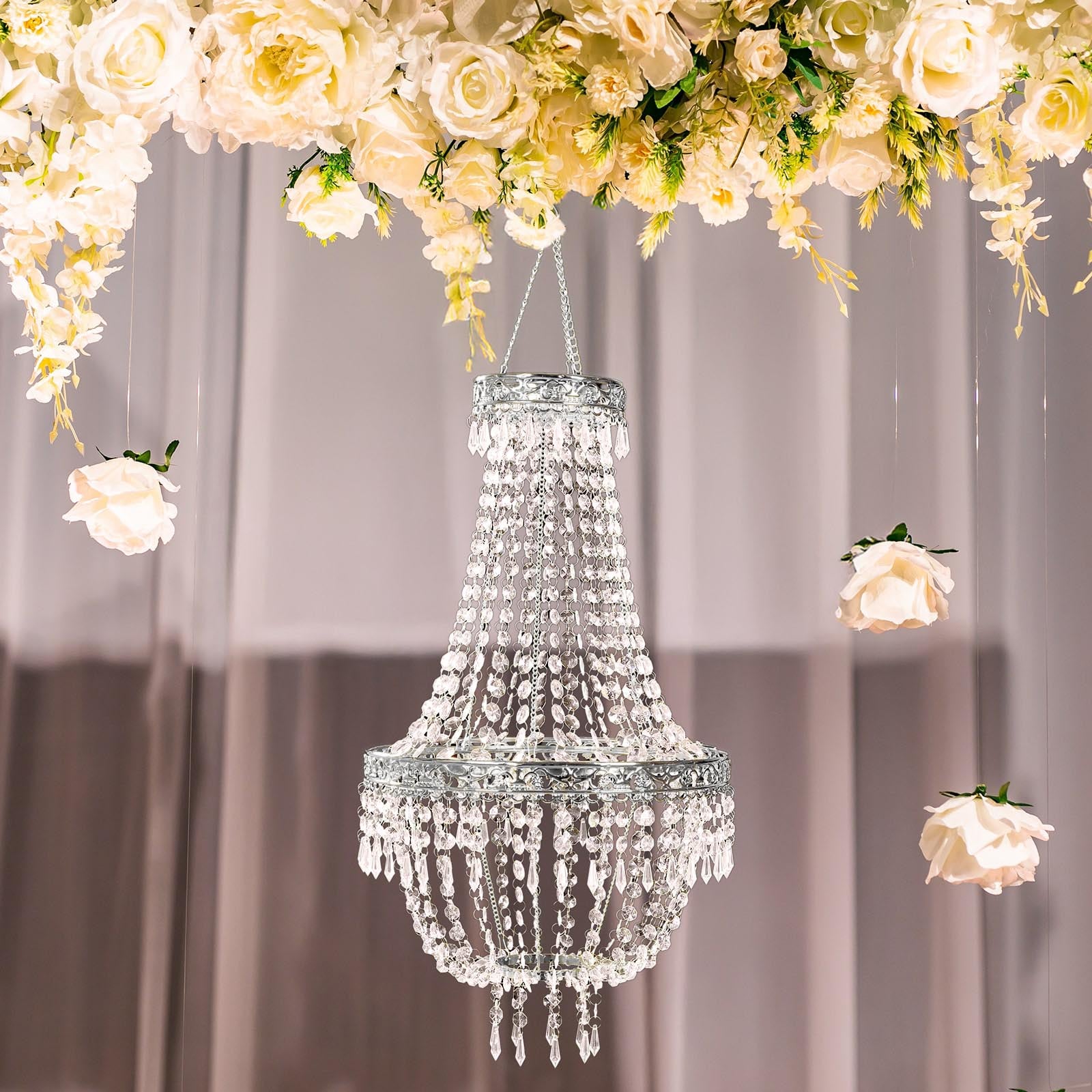 Silver beaded crystal chandelier with ornate metal frame.