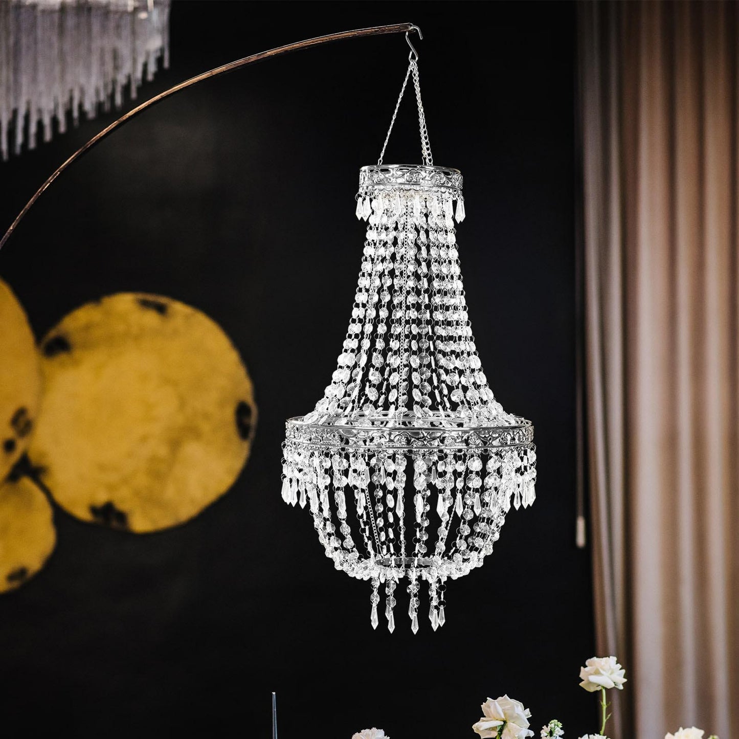 Silver beaded crystal chandelier with ornate metal frame.