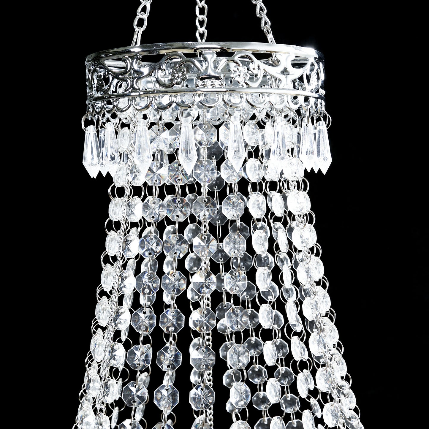 Silver beaded crystal chandelier with ornate metal frame.