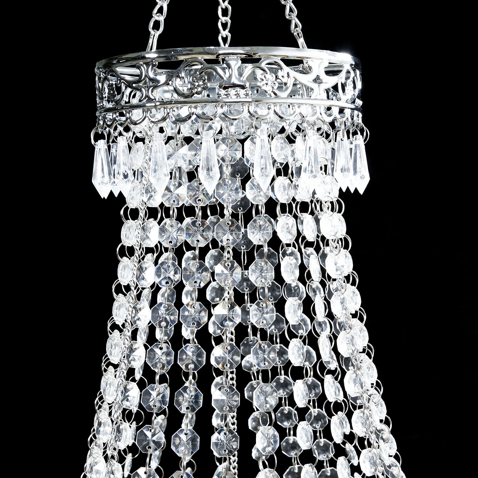 Silver beaded crystal chandelier with ornate metal frame.