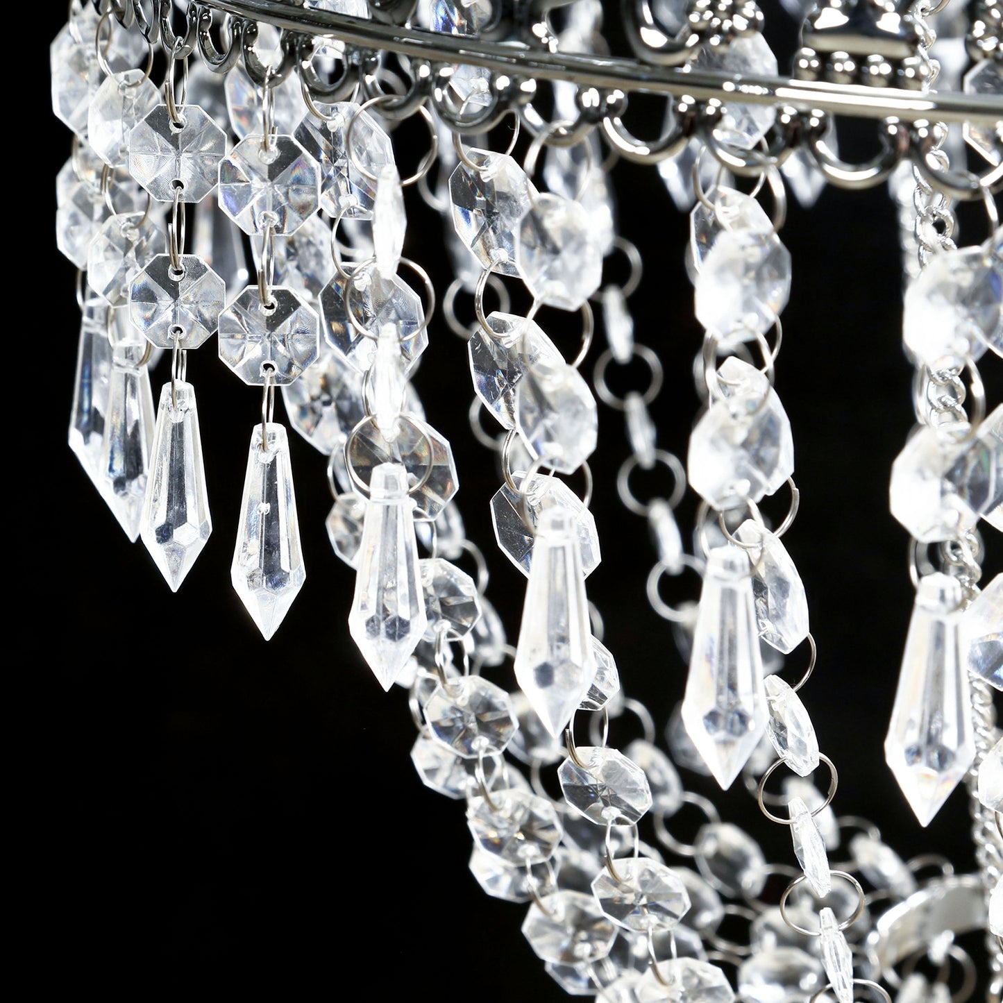Silver beaded crystal chandelier with ornate metal frame.