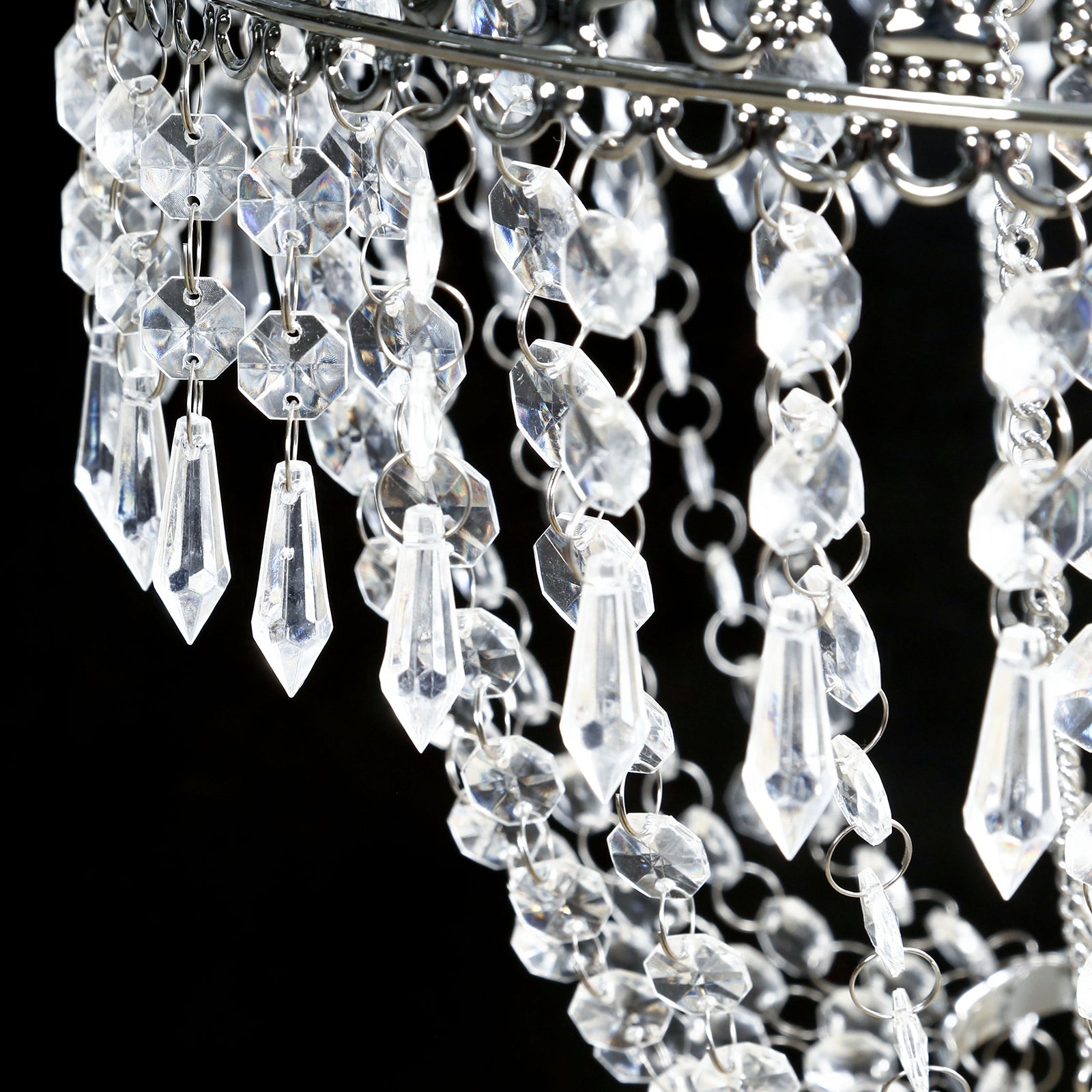 Silver beaded crystal chandelier with ornate metal frame.