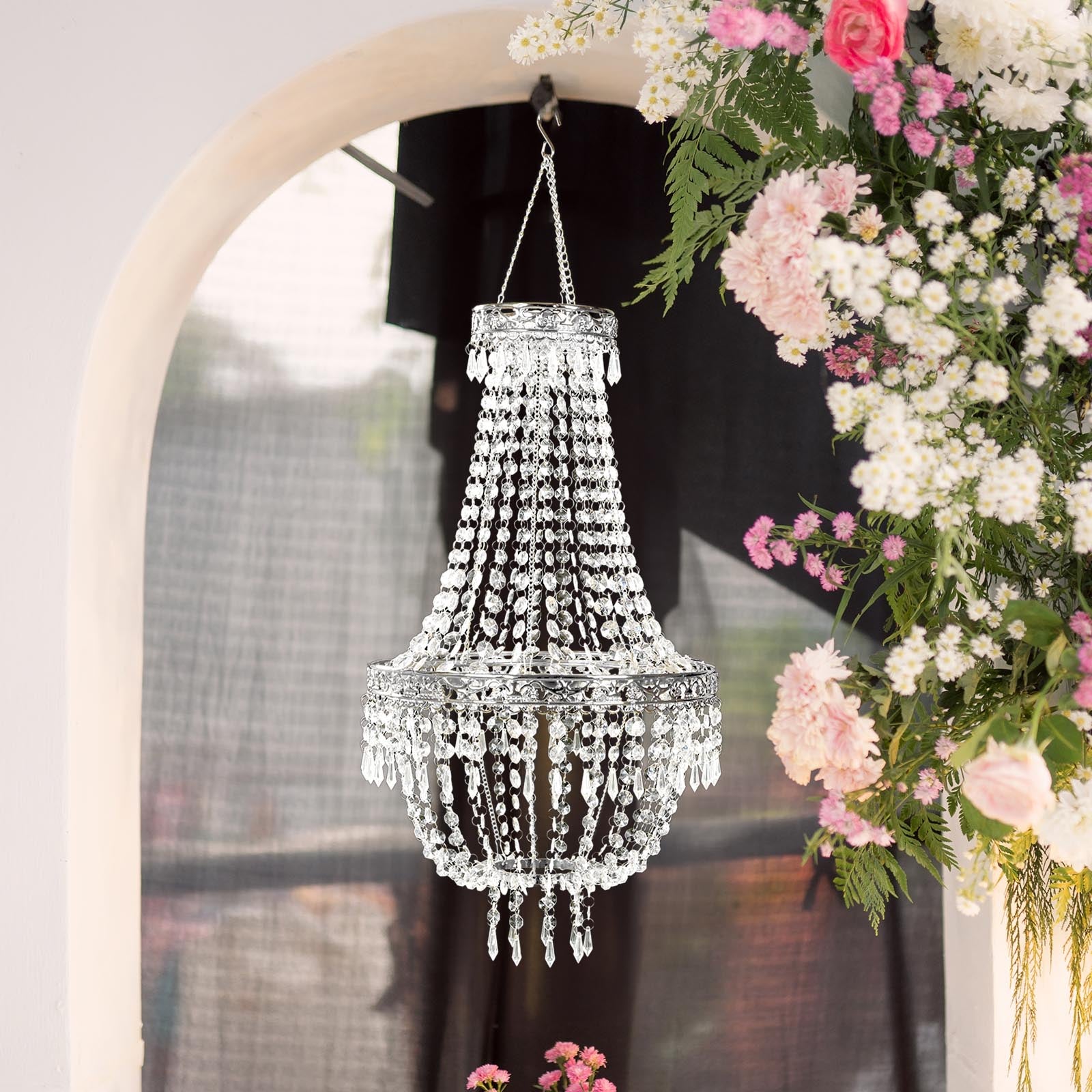 Silver beaded crystal chandelier with ornate metal frame.