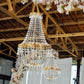 Gold beaded crystal chandelier with ornate metal frame, adjustable pendant lighting.