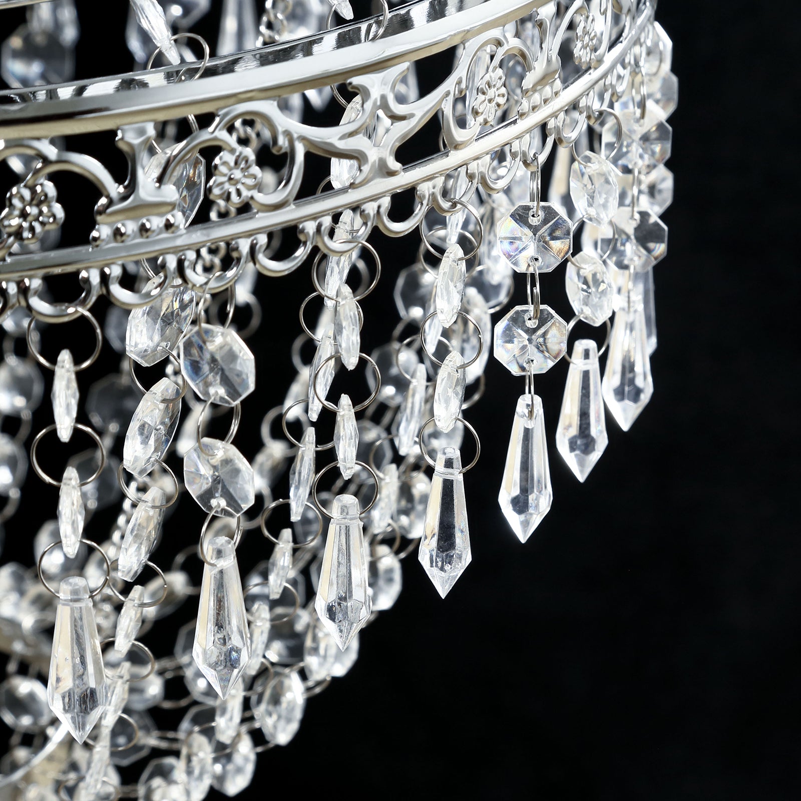 Silver beaded crystal chandelier with ornate metal frame.