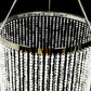 White beaded crystal chandelier with silver metal hoop and chain.