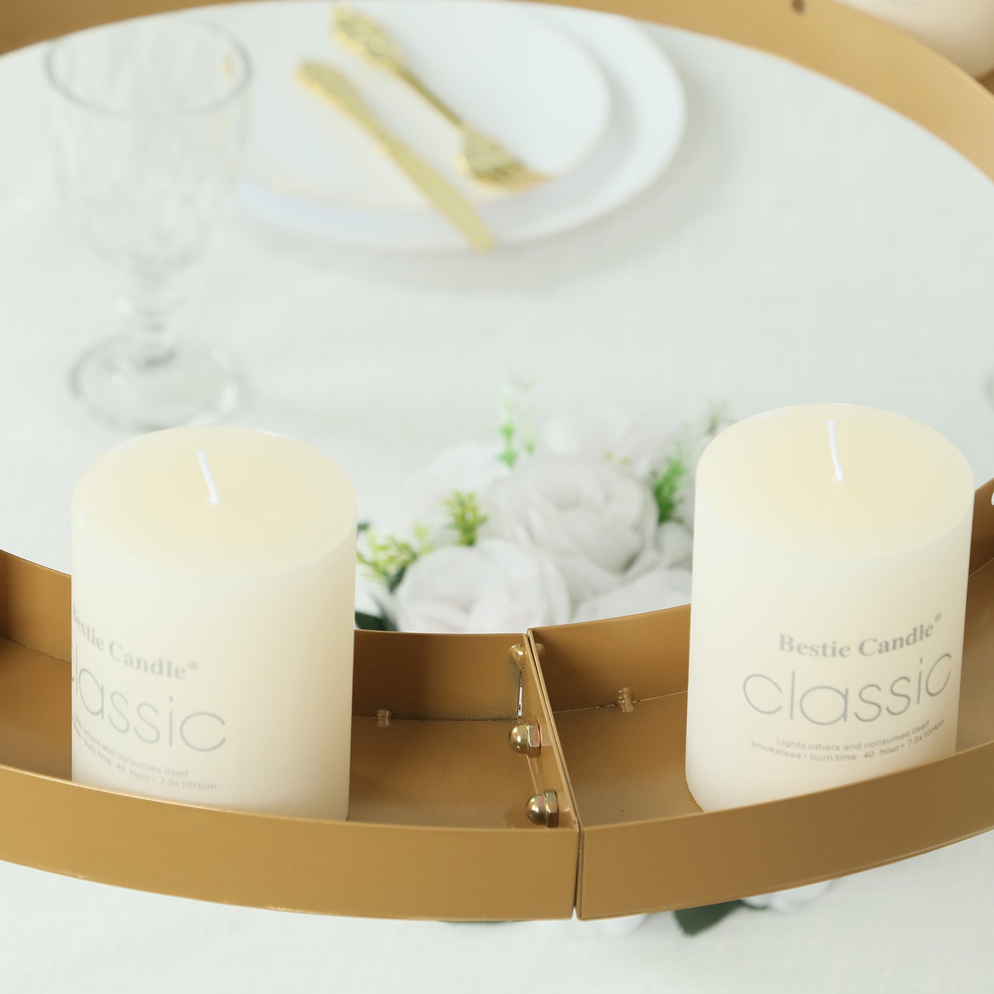 Gold floral chandelier frame with candles and floral display.