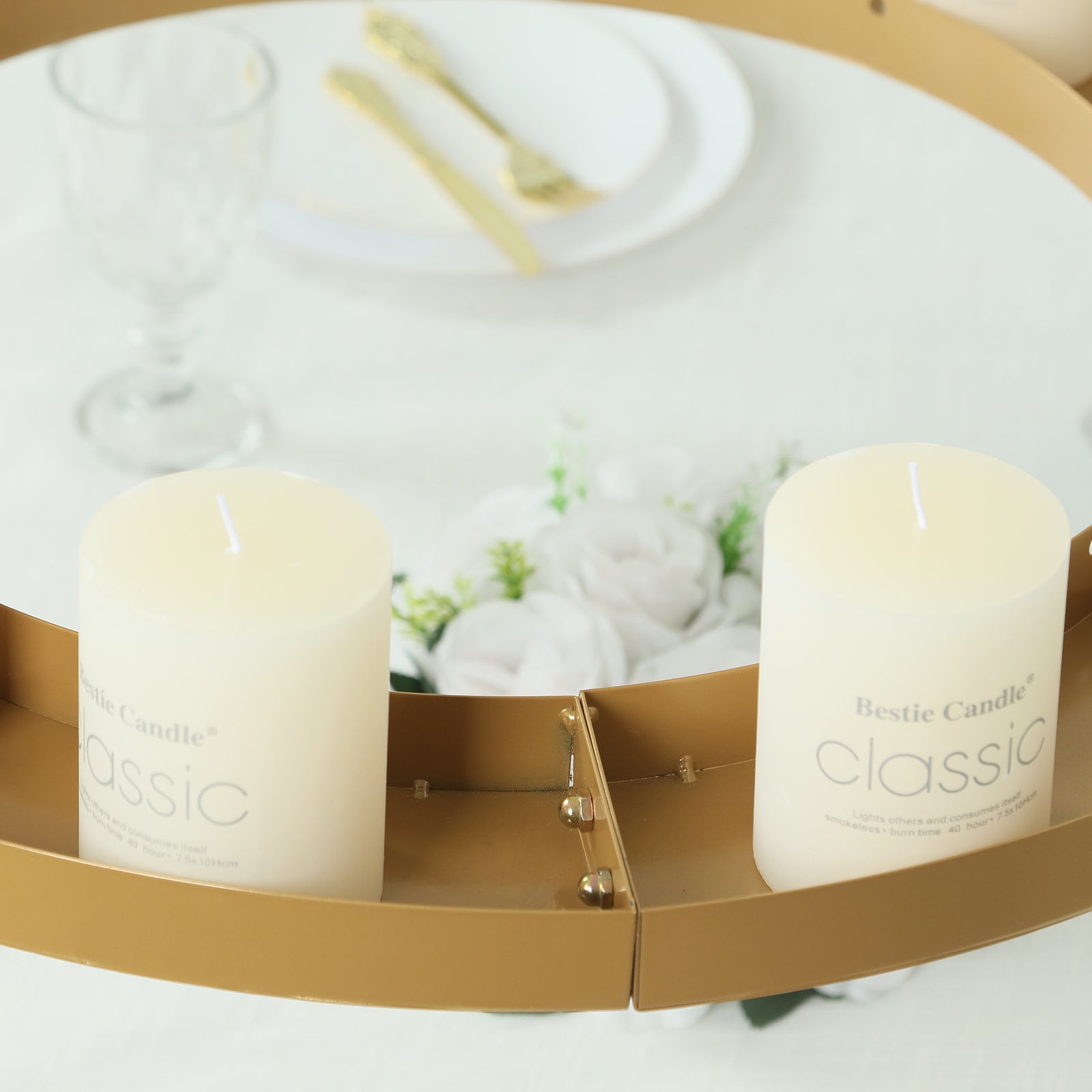 Gold floral chandelier frame with candles and floral display.