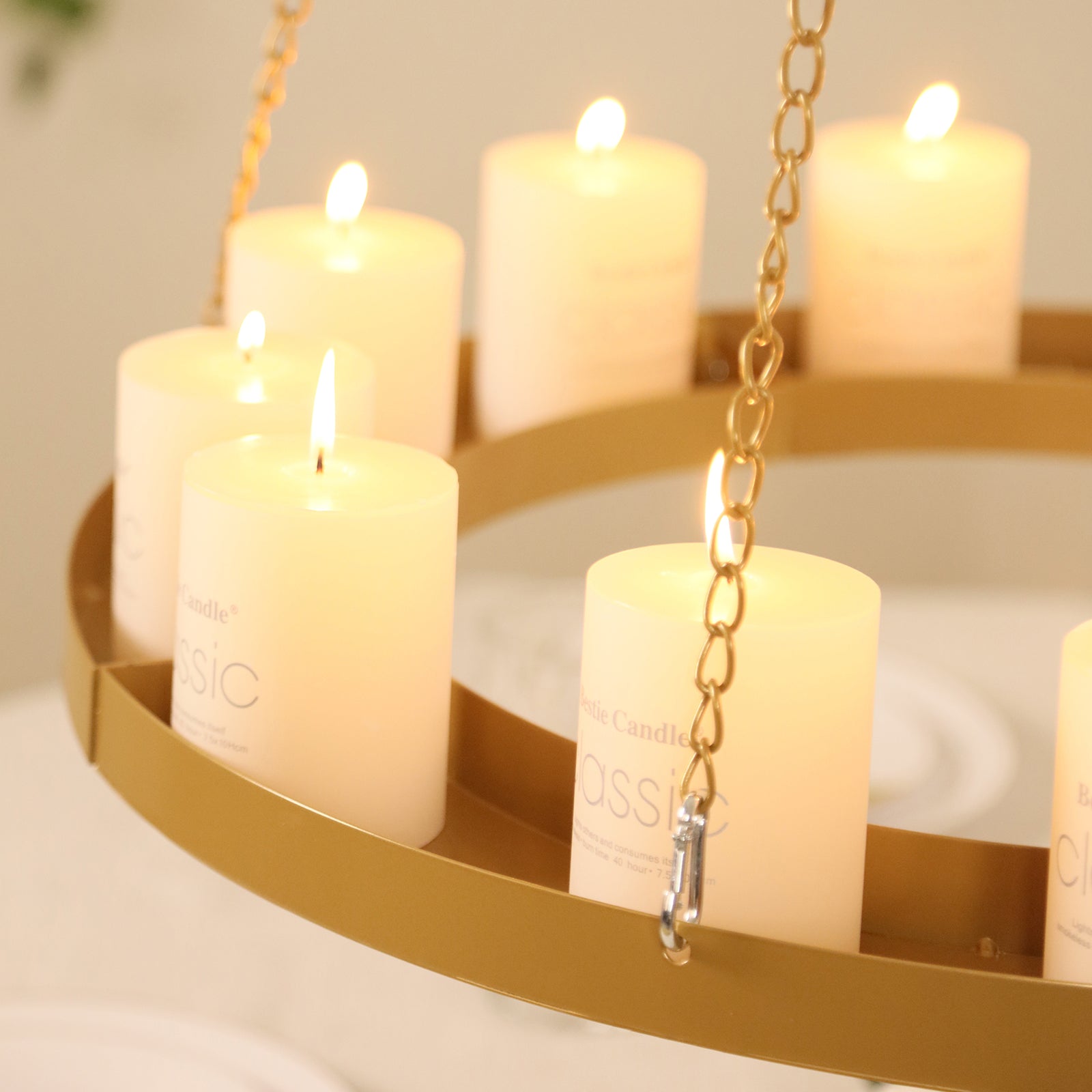 Gold chandelier frame with candles and floral display, elegantly lit.