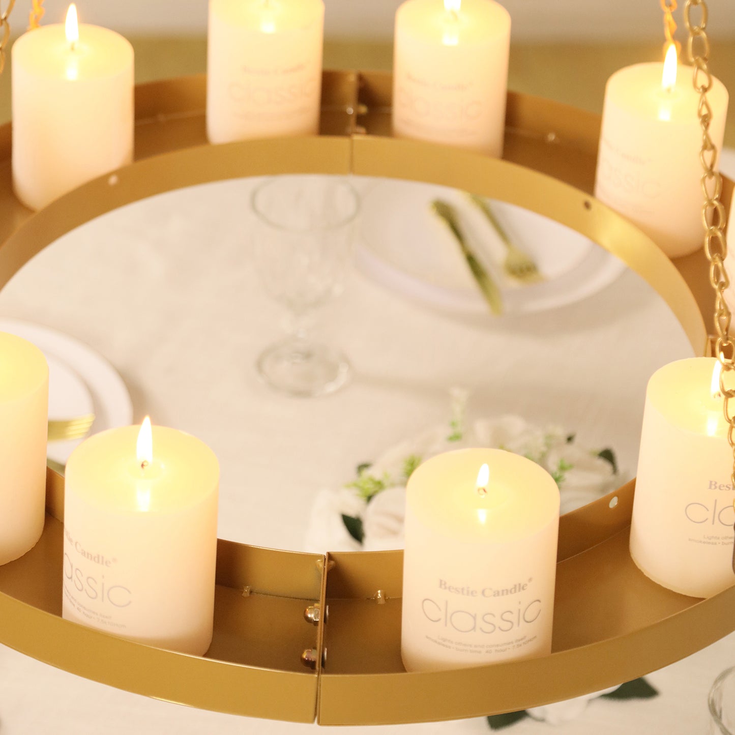 Gold floral chandelier with candles and floral display.