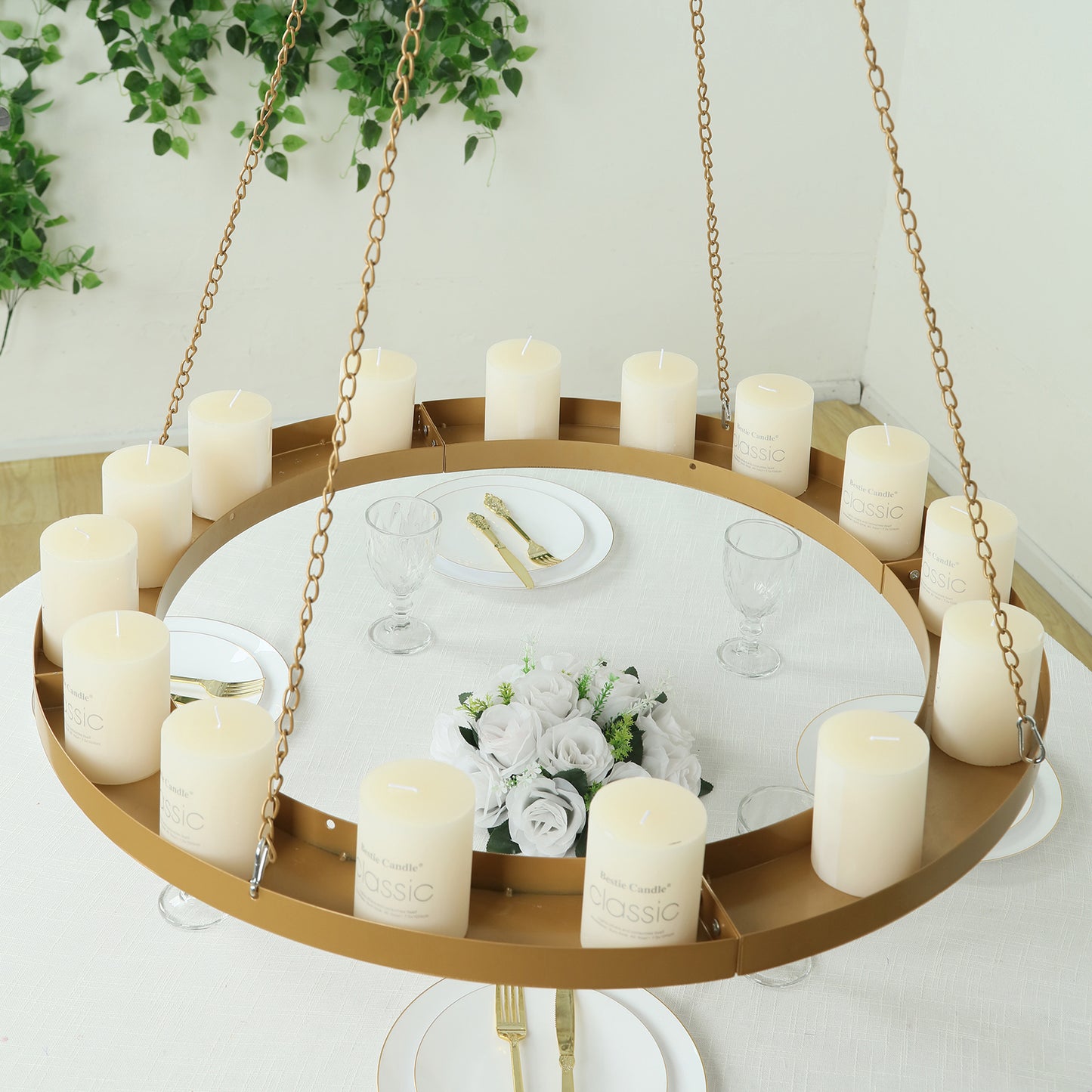 Gold hanging floral chandelier with candles and floral display.