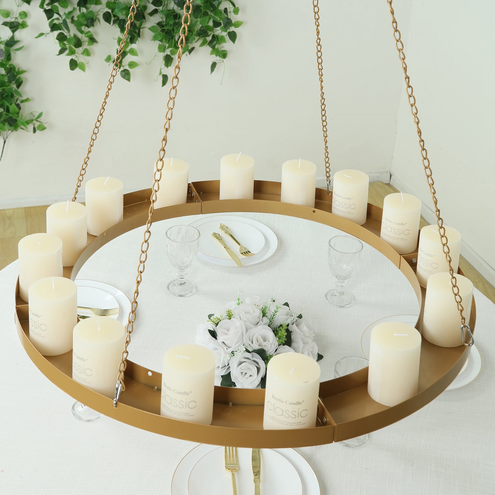 Gold hanging floral chandelier with candles and floral display.