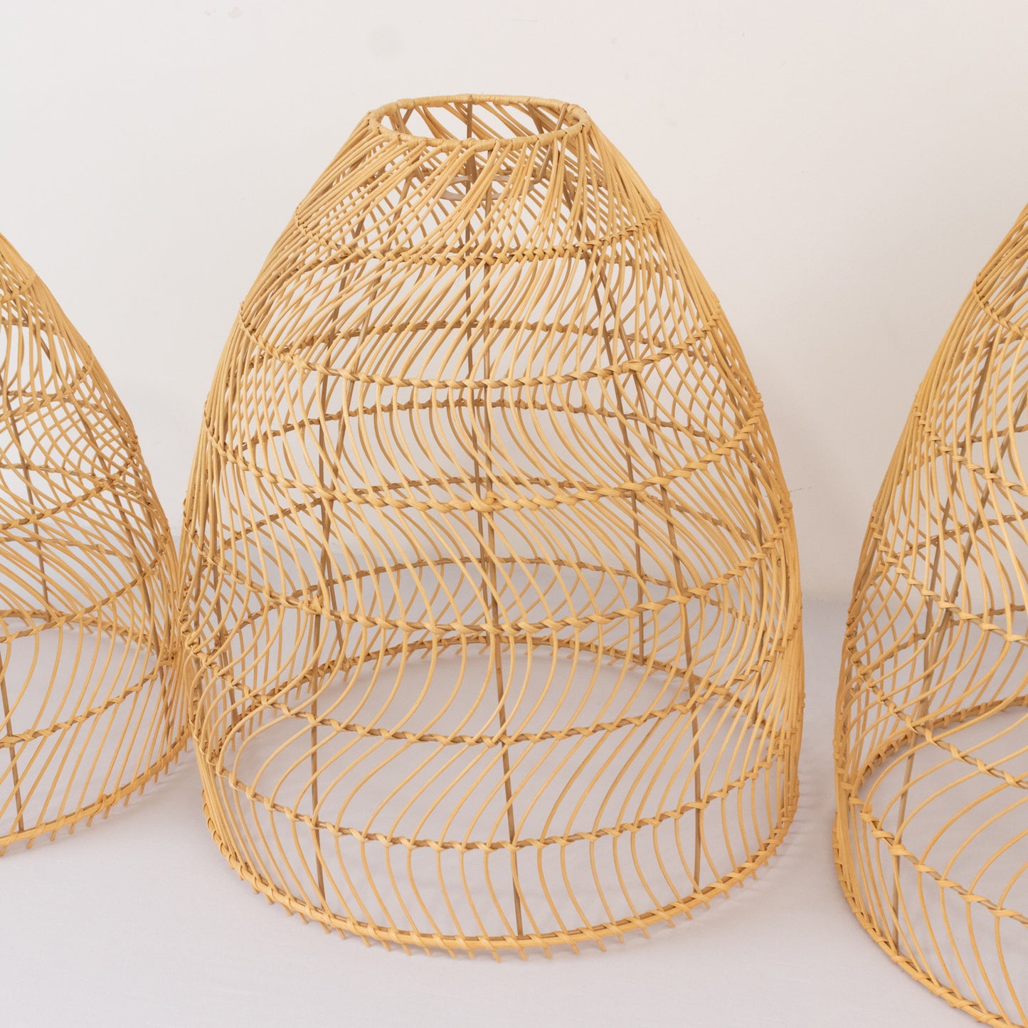 Natural woven rattan pendant lamp shades set of 3 in cone shape.