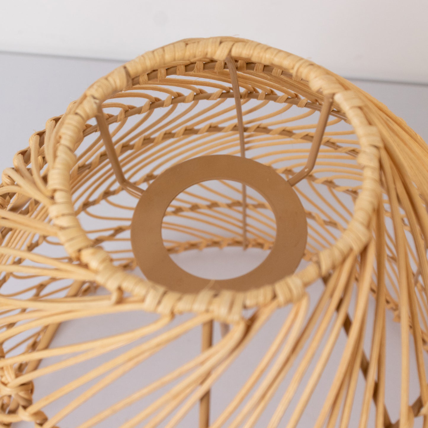 Natural woven rattan light shade in cone shape.