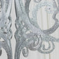 Silver glittered acrylic chandelier decor with 3D interlocking cutout design.