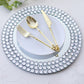 Silver mirror glass charger plate with diamond beaded rim and gold utensils.