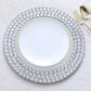 Silver round charger plate with diamond beaded rim.