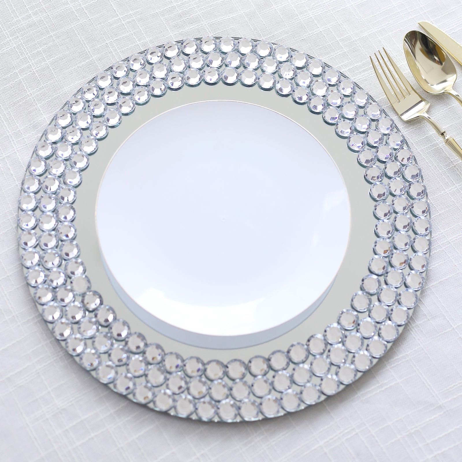 Silver round charger plate with diamond beaded rim.