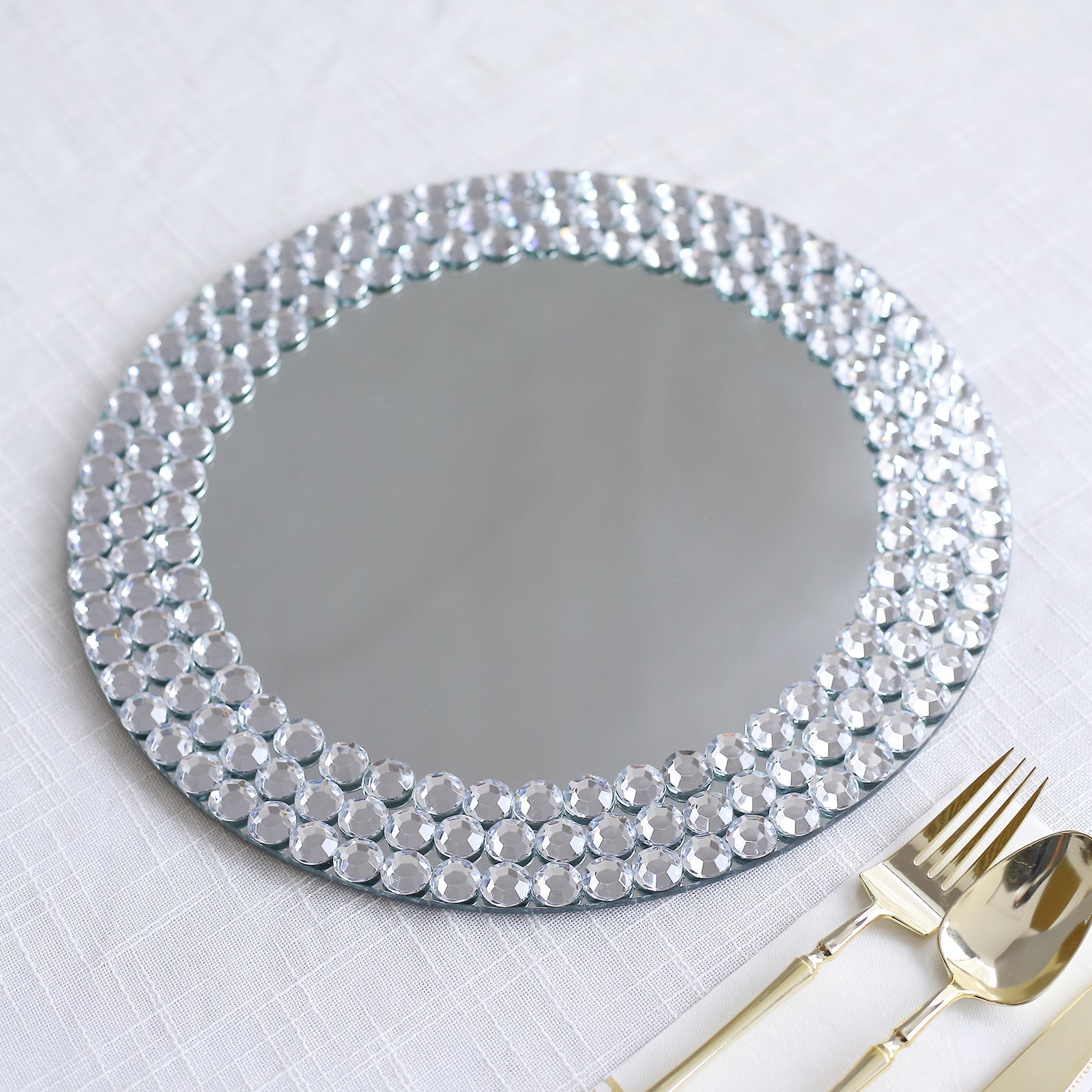 Silver mirror glass charger plate with diamond beaded rim.