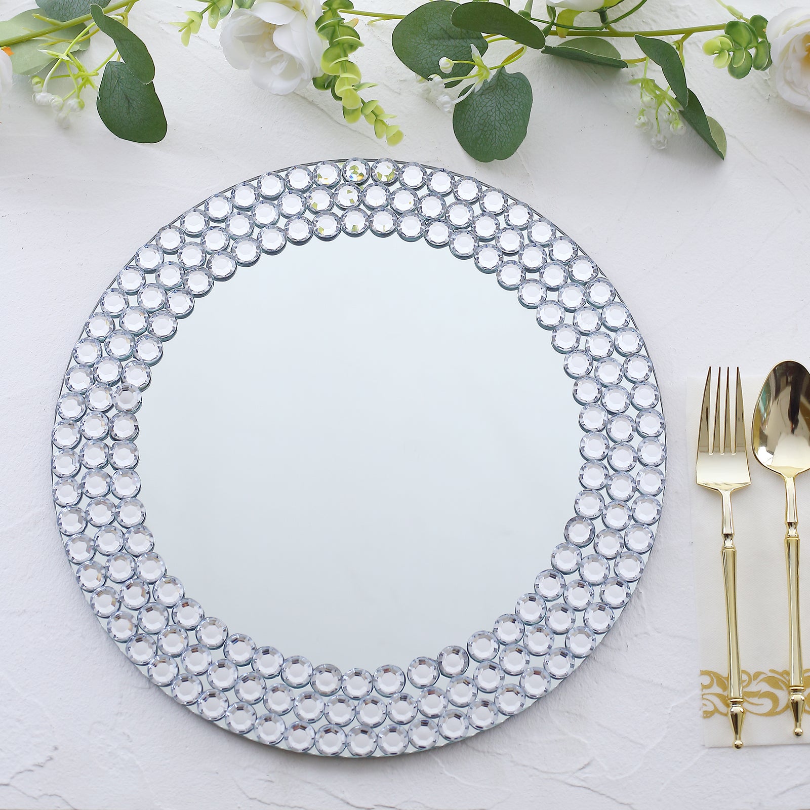 Silver round mirror charger plate with diamond beaded rim.