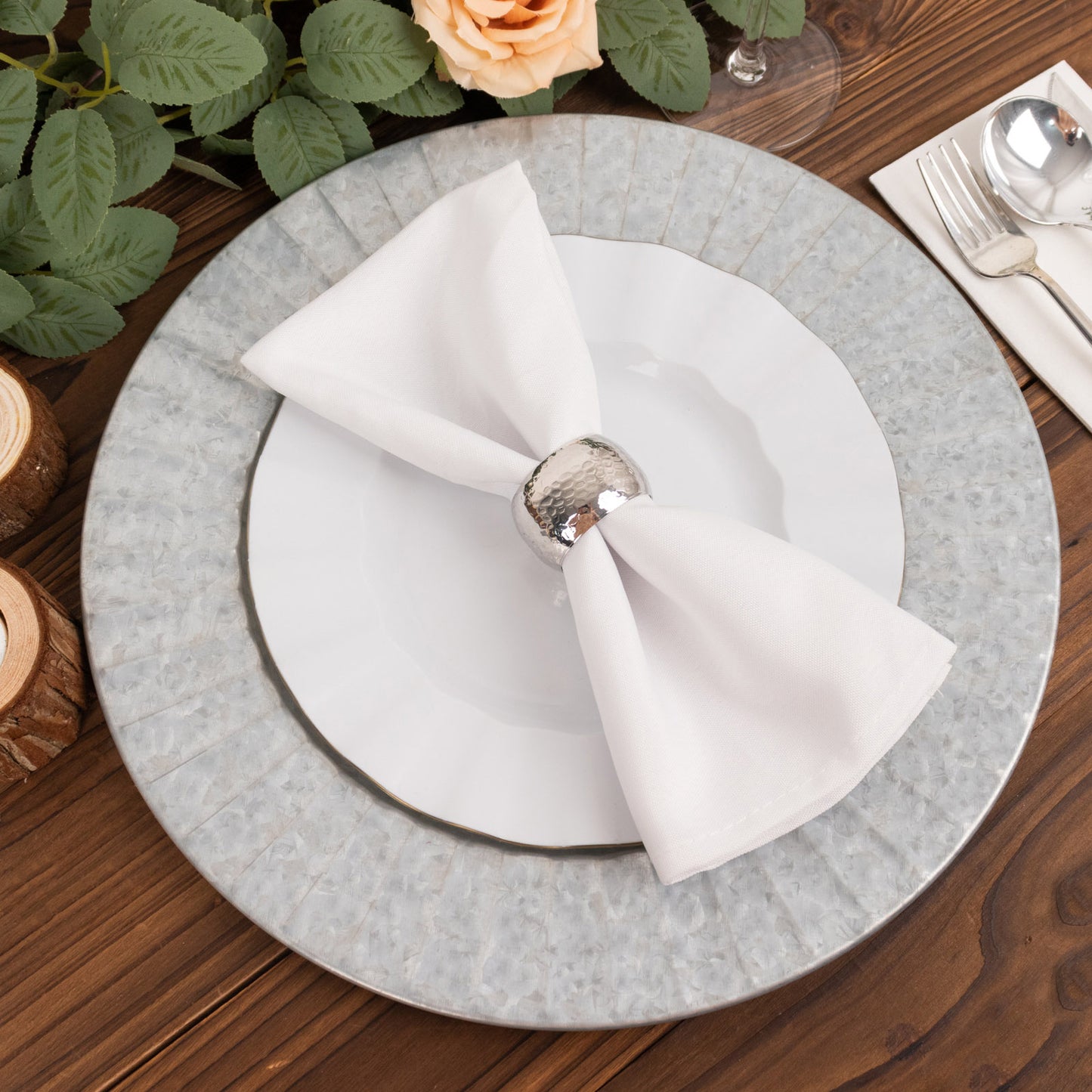 Silver galvanized metal charger plate with ruffled rim.