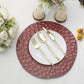 Burgundy hammered charger plate with gold utensils on a white table setting.