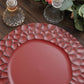 Matte finish burgundy hammered charger plate on a wooden table.
