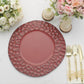 Burgundy hammered charger plate on a table with floral decor and utensils.