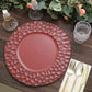Burgundy hammered charger plate on a wooden table setting.