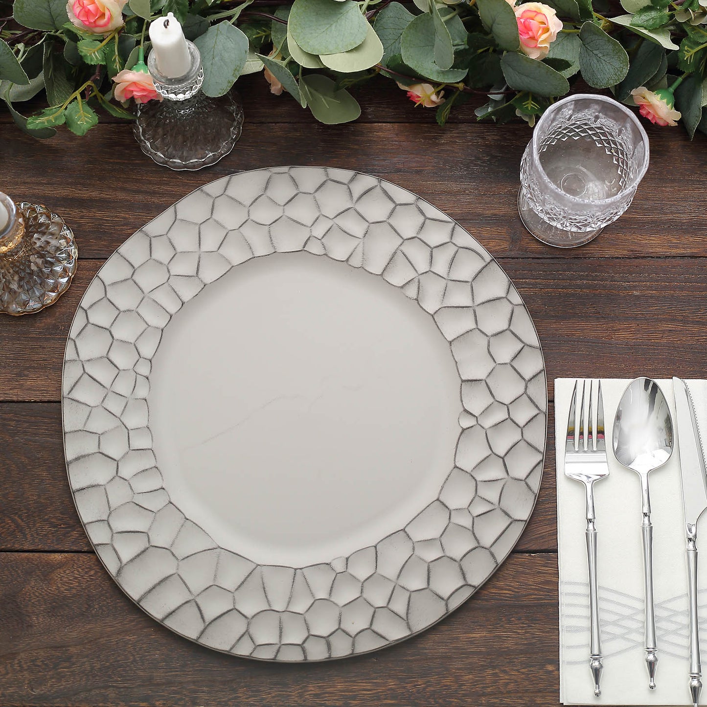 Matte finish gray hammered charger plate on a wooden table setting.
