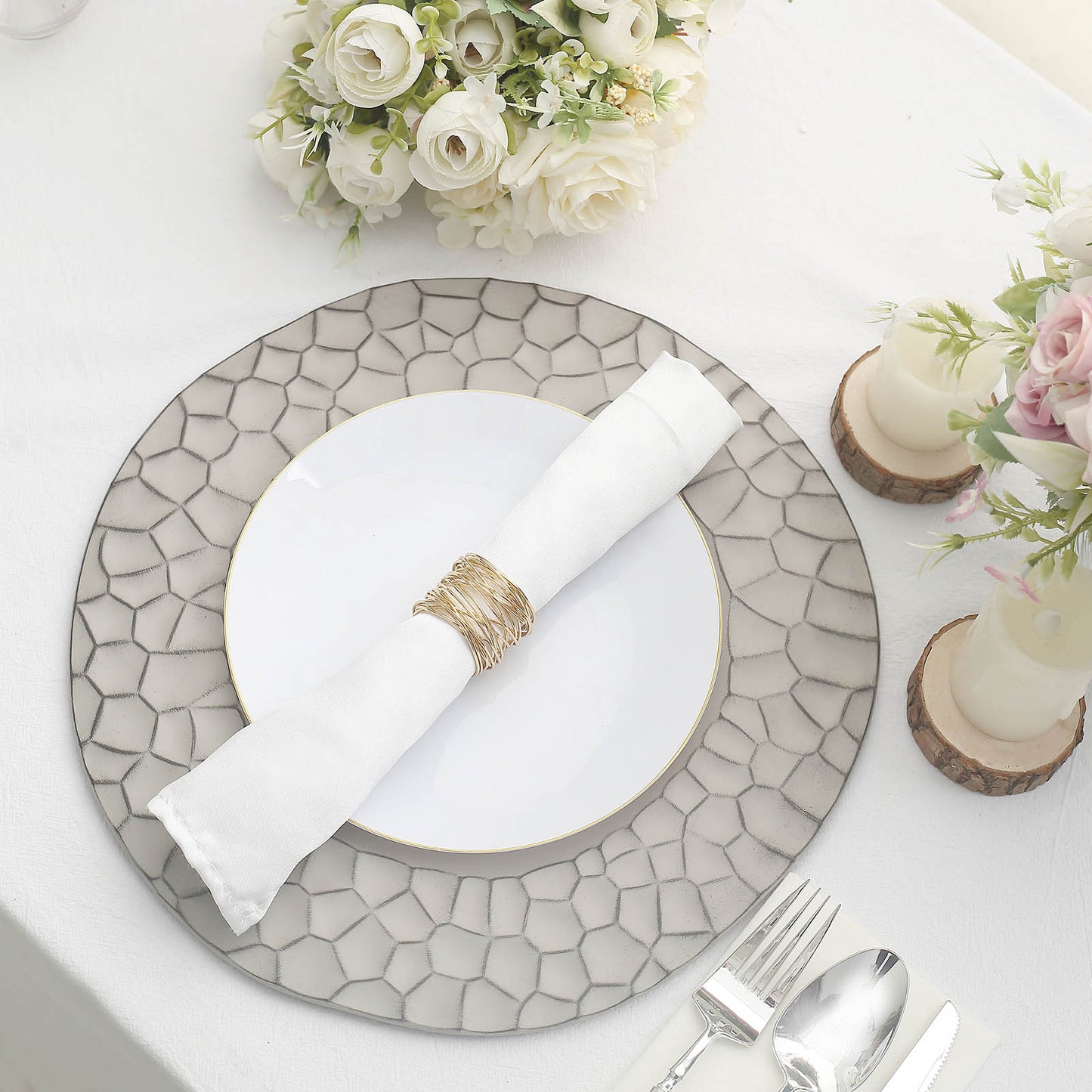 Matte finish gray hammered charger plate on a dining table setting.