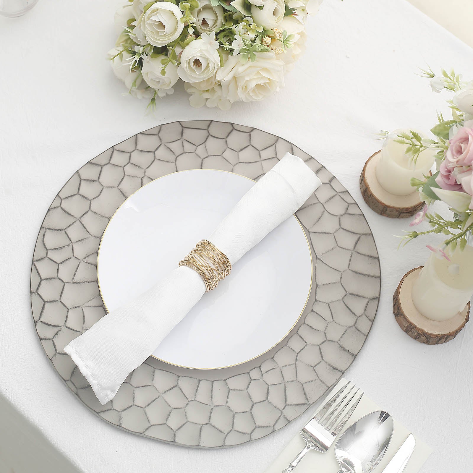 Matte finish gray hammered charger plate on a dining table setting.