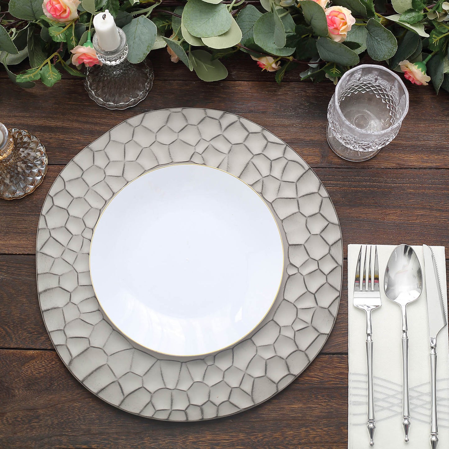 Matte gray hammered charger plate on a wooden table setting.