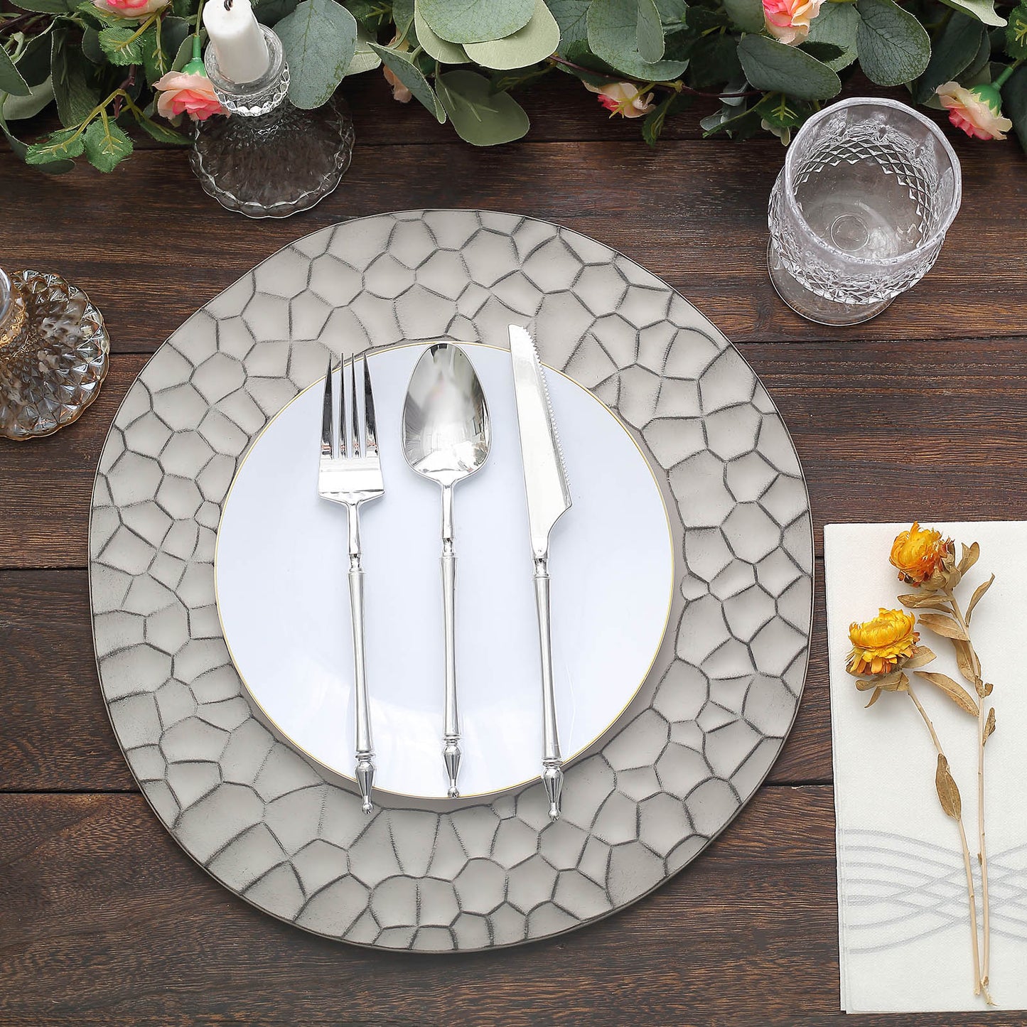 Matte gray hammered charger plate with modern dinnerware setting.